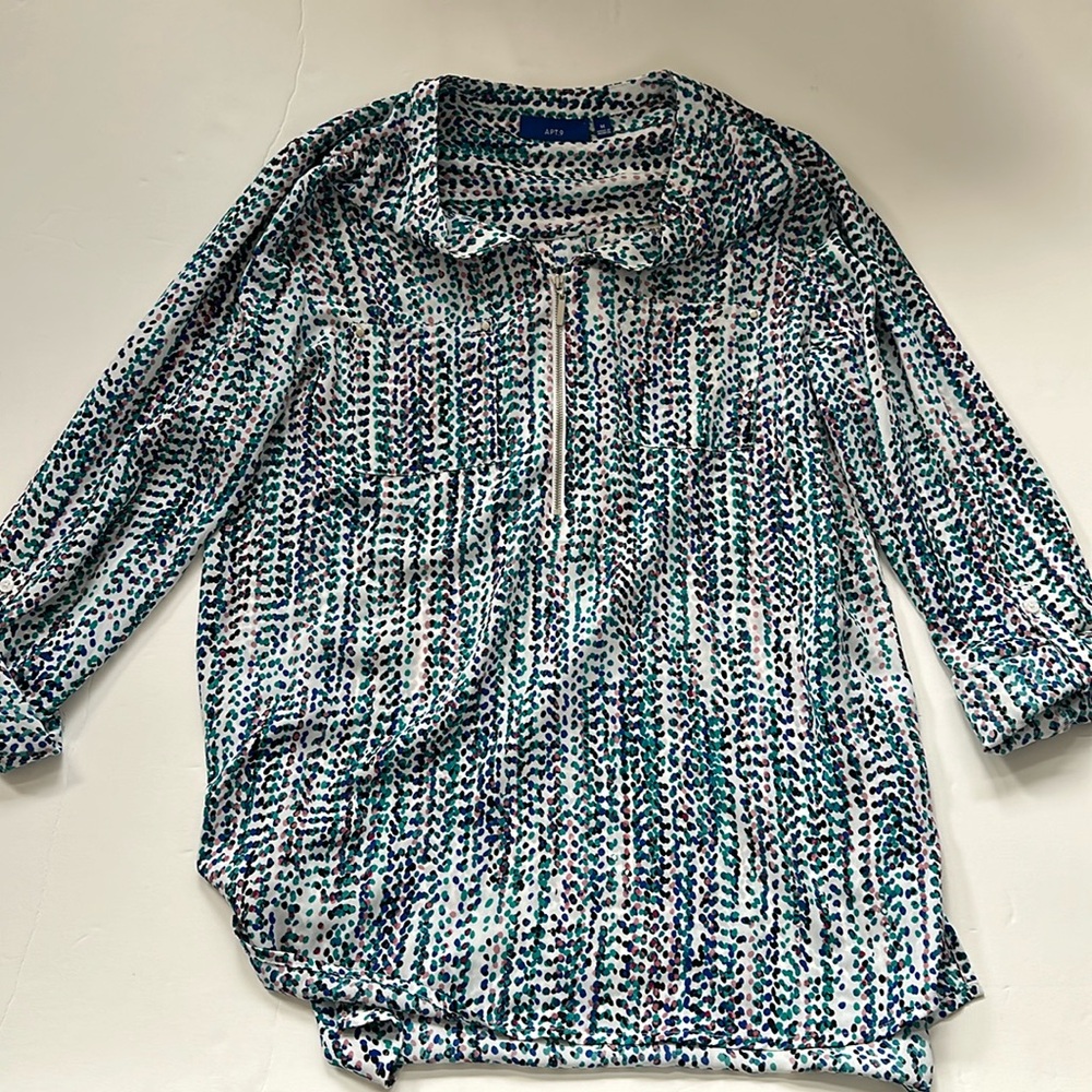 Women’s 1/4” zip, polyester blouse. Dotted print